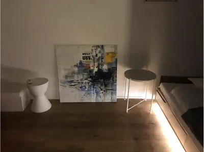 a room with two chairs and a painting on the wall at Shimokitazawa Private House in Tokyo