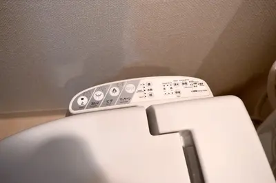 a remote control sitting on top of a toilet at Roppongi Cat House601 in Tokyo