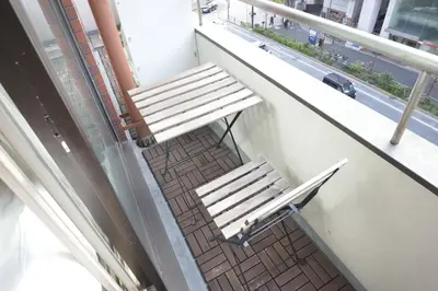 a bench sitting on a balcony next to a window at Roppongi Cat House601 in Tokyo