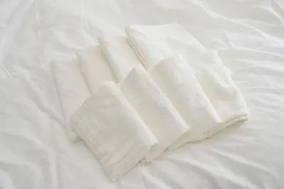 a pile of white towels on a bed at Roppongi Cat House601 in Tokyo