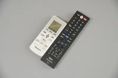 a calculator and a remote control sitting on a table at Roppongi Cat House601 in Tokyo