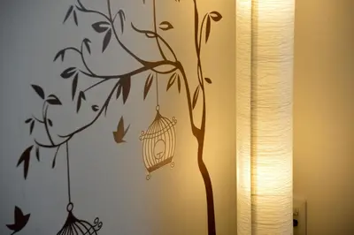 a wall stencil of a bird cage on a wall at Roppongi Japan House602 in Tokyo