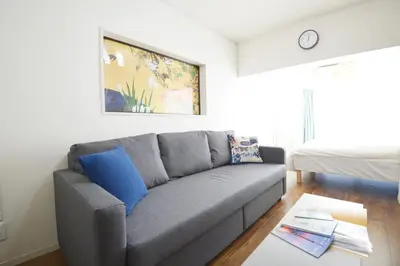 a living room with a couch and a bed at Roppongi Japan House602 in Tokyo