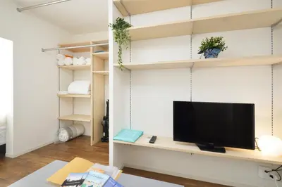 a living room with a television on a desk at Roppongi Japan House602 in Tokyo