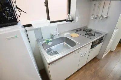 a small kitchen with a sink and a refrigerator at Roppongi Japan House602 in Tokyo