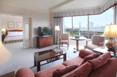 a living room with a couch and a bed at Hotel Chinzanso Tokyo in Tokyo