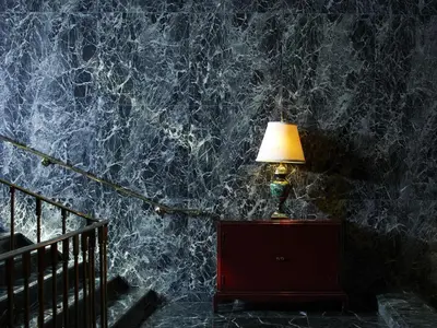 a lamp on a dresser next to a marble wall at Hotel Chinzanso Tokyo in Tokyo
