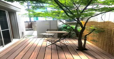 a wooden deck with a table and a tree at 3-25-2 Higashiogu - Apartment / Vacation STAY 8340 in Tokyo