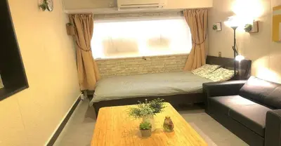 a small living room with a couch and a table at 3-25-2 Higashiogu - Apartment / Vacation STAY 8340 in Tokyo