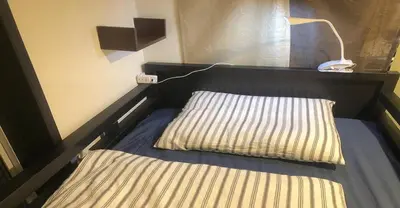 a bed with a pillow and a lamp in a room at 3-25-2 Higashiogu - Apartment / Vacation STAY 8342 in Tokyo