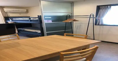 a table and chairs in a room with a bunk bed at 3-25-2 Higashiogu - Apartment / Vacation STAY 8342 in Tokyo
