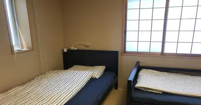 a bedroom with two beds and a window at 3-25-2 Higashiogu - Apartment / Vacation STAY 8348 in Tokyo