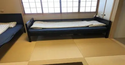 a bed sitting in a room with a window at 3-25-2 Higashiogu - Apartment / Vacation STAY 8348 in Tokyo