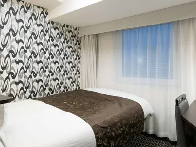 a hotel room with a bed and a window at APA Hotel Ueno Inaricho Ekikita in Tokyo