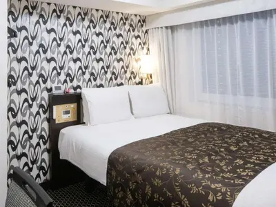 a hotel room with a bed and a window at APA Hotel Ueno Inaricho Ekikita in Tokyo