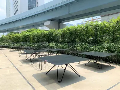 a row of tables and chairs sitting on a building at HOTEL TAVINOS Hamamatsucho in Tokyo