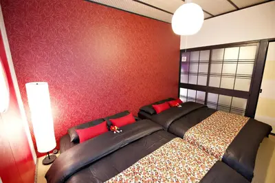 a bedroom with a large bed with red pillows at IROHA Residential Suite Asakusa Skytree in Tokyo