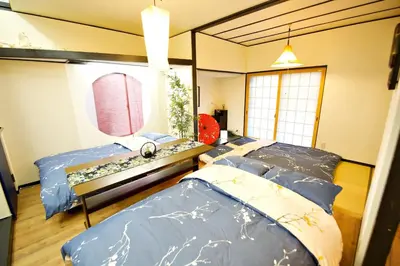 a room with two beds and a painting on the wall at IROHA Residential Suite Asakusa Skytree in Tokyo