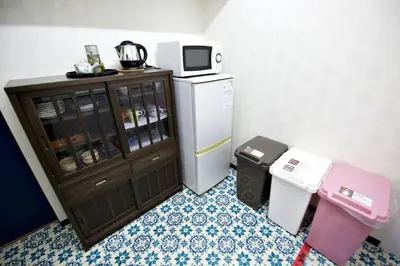 a small kitchen with a refrigerator and a microwave at IROHA Residential Suite Asakusa Skytree in Tokyo