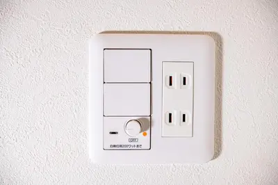 a white light switch on a wall at bnb+ Ueno Okachimachi in Tokyo