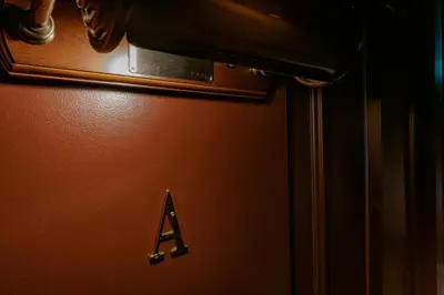 a refrigerator with a alphabet on the side of it at bnb+ Ueno Okachimachi in Tokyo