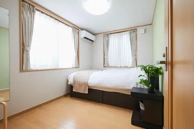 a bedroom with a bed and two windows at G48-Superior Room in Shinjuku, Tokyo in Tokyo