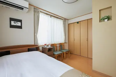 a bedroom with a bed and a desk and a window at G48-Superior Room in Shinjuku, Tokyo in Tokyo