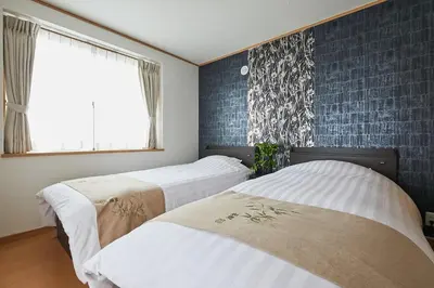 two beds in a room with blue walls and a window at G48-Superior Room in Shinjuku, Tokyo in Tokyo