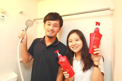 a man and a woman holding up a bottle ofetchup at IBASHO ShibuyaDogenzaka803 in Tokyo