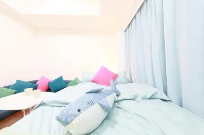 a bedroom with a shark pillow on a bed at IBASHO ShibuyaDogenzaka803 in Tokyo
