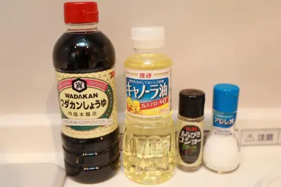 a bottle of soy sauce next to other ingredients on a counter at IBASHO ShibuyaDogenzaka907 in Tokyo
