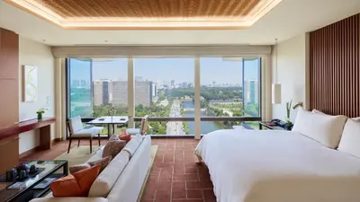 a hotel room with a large bed and a large window at The Peninsula Tokyo in Tokyo
