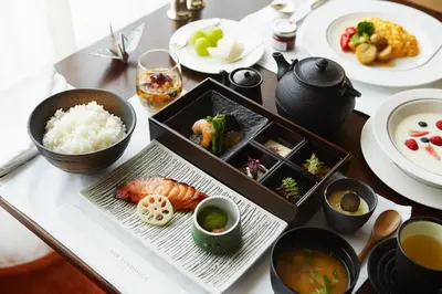 a table topped with plates and bowls of food at The Peninsula Tokyo in Tokyo