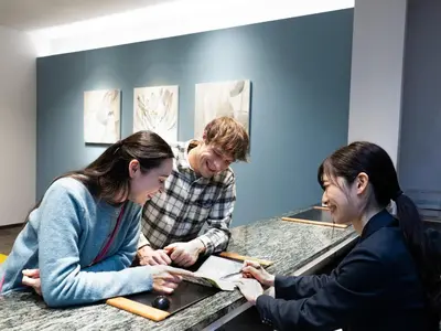 a man and two women sitting at a counter at Tokyu Stay Suidobashi in Tokyo