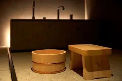 a table and a bench in a room with a counter at TSUKI Tokyo in Tokyo