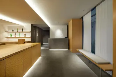 an office lobby with a reception desk and benches at TSUKI Tokyo in Tokyo