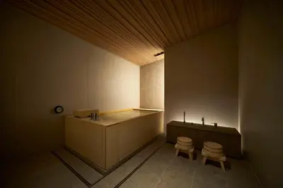 a bathroom with a tub and two stools in it at TSUKI Tokyo in Tokyo