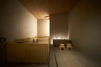 a bathroom with two toilets and a sink in a room at TSUKI Tokyo in Tokyo