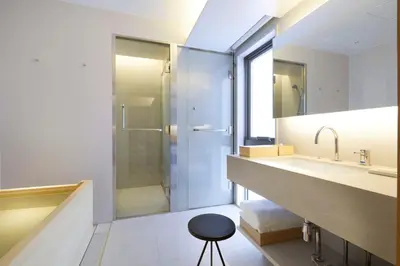 a bathroom with a sink and a shower and a stool at TSUKI Tokyo in Tokyo
