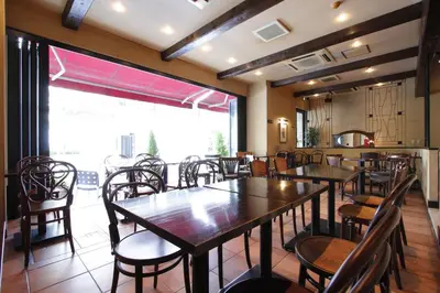 a restaurant with tables and chairs and a large window at Kadoya Hotel in Tokyo
