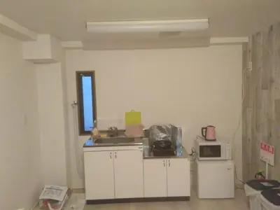 a kitchen with a sink and a microwave at Nice Hostel Kameari in Tokyo