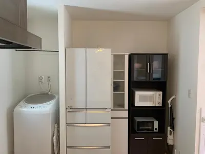 a kitchen with a refrigerator and a microwave at 3LDK, Functional and New house in convenient Shinjuku in Tokyo