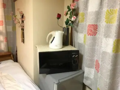 a microwave with a coffee maker on top of it at \u30db\u30c6\u30eb\u3072\u304b\u308a in Tokyo