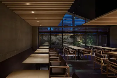 a row of tables and chairs in a restaurant at ONSEN RYOKAN YUEN SHINJUKU in Tokyo