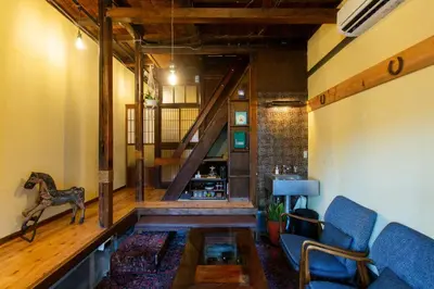 a living room with a staircase and blue chairs at Shinagawa-ku - House / Vacation STAY 12126 in Tokyo