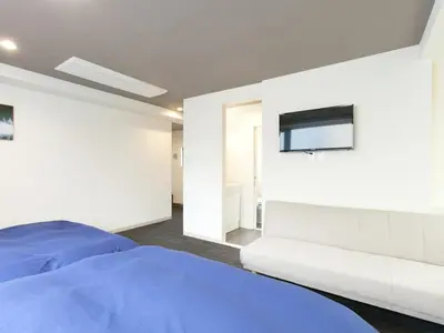 a bedroom with a bed and a tv on the wall at Hotel Cocoro Inn Asakusa Kuramae in Tokyo