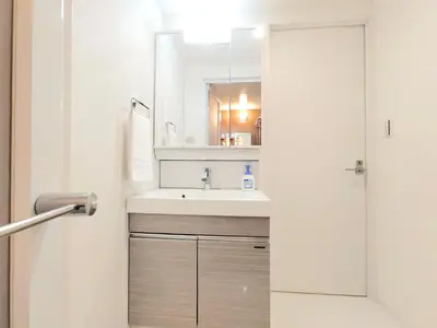 a bathroom with a sink and a mirror at LANG Hotel Ginza 1LDK in Tokyo