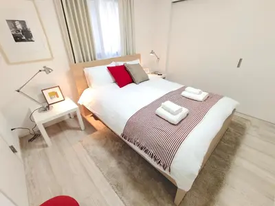 a bedroom with a large bed with two pillows on it at LANG Hotel Ginza 1LDK in Tokyo