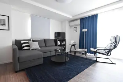 a living room with a couch and a table at LANG Hotel Ginza 1LDK in Tokyo