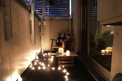 a balcony with lights on the floor and a chair at Kyodo Private House in Tokyo